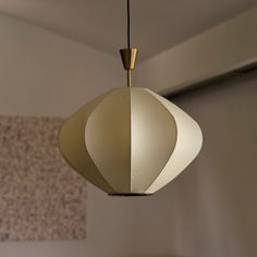 a white lamp hanging from a ceiling in a room