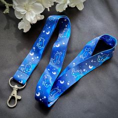 Show off your unique style with the Stellar Bunnies Lanyard! Made of durable polyester, it's 18" long and 0.8" wide with a lobster clasp, so you can carry your valuables securely and in style. Featuring cute bunnies dancing among stars and moons, it's perfect for holding ID badges, keys or your favorite Ika Ink keychain! DETAILS * 18 inches long * 0.8 inches wide * Sublimated polyester NOTES * Colors on images may vary between monitors depending on calibration or screen settings. As such, the co Butterfly Lanyard Cute, Bunnies Dancing, Bunny Dance, Moon Rabbit, Stars And Moons, Cute Bunnies, Badge Holder, Id Badge, Badge Holders