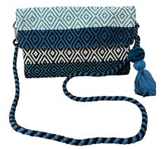 "Our unique and beautiful hand loomed envelope bags are the perfect \"statement\" piece to wear day or night and perfect for  travel.   The loom of our handloom bags are manually operated by skilled artisans that weave fabrics  utilizing a four-pedal weaving technique.  It involves using  four pedals to create differente patterns in the fabric...an extremely difficult technique that requires much more skill and experience from a weaver.   Each tasseled bag has cotton lining with an inner zip poc Blue Handwoven Bag As A Gift, Blue Travel Bag With Weaving Detail, Blue Bohemian Clutch For Everyday Use, Blue Bohemian Clutch For Daily Use, Bohemian Blue Clutch For Daily Use, Blue Woven Crossbody Shoulder Bag, Traditional Blue Handwoven Bags, Traditional Blue Rectangular Shoulder Bag, Blue Woven Pouch Shoulder Bag