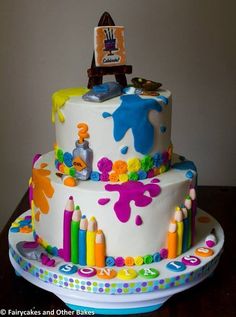 a birthday cake is decorated with colorful crayons