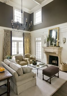 a living room filled with furniture and a fire place in the middle of a room