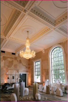 a chandelier hangs from the ceiling in an old building