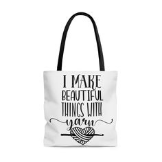 a white tote bag with the words i make beautiful things with yarn on it