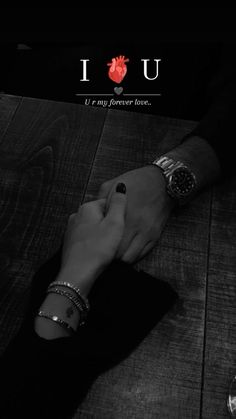 two people holding hands with the words i love you written on them in black and white