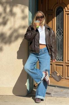 leather jacket, coffee, jeans, sambas Gray Jeans Fall Outfit, Cool Girl Outfits Fall, Denver Street Style, Cordory Jacket Outfits, Fall Nyc Fashion, Fall Anniversary Outfit Ideas, Dark Low Rise Jeans Outfit, Cool Girl Outfits Aesthetic, Milan Outfits Fall