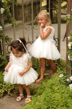 Dress your little princess in the Mini Fairy Garden Dress in White, a whimsical ensemble designed for enchanting adventures. Featuring a square neckline and cap-length ruffle sleeves, this dress boasts a knee-length skirt with a delicate crinoline underlay for extra flair. Complete with a hidden back zipper and a comfortable smocked back detail, it’s perfect for twirling through fairytale realms and making magical memories. Fairy Garden Dress, Thanksgiving Dress, Girls Holiday Dresses, Mini Fairy Garden, Baby Fairy, Garden Dress, White Dress Party, Holiday Party Dresses, Dreamy Dress