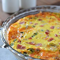 an omelet with ham and spinach in a glass dish on a table