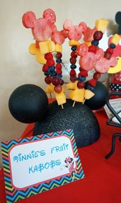 a mickey mouse themed party with fruit and candy