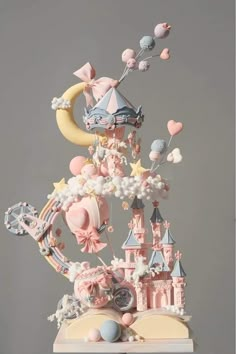 a cake that is made to look like a castle with balloons and stars on it