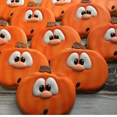 many decorated pumpkins with faces on them