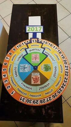 the wheel of fortune is on display in front of a tile floor