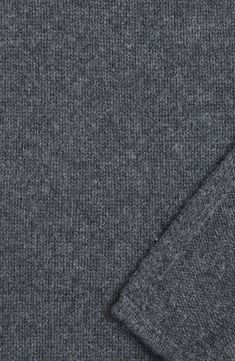 a close up view of the back of a gray sweater with a pocket on it