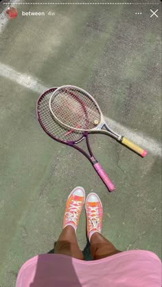 a tennis racket and shoe on the ground with someone's feet propped up