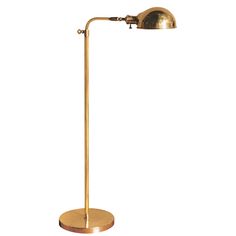 a brass plated floor lamp on a white background