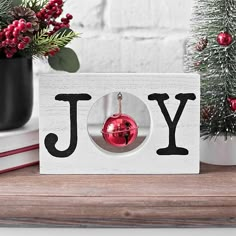 a christmas ornament with the word joy hanging from it's center piece