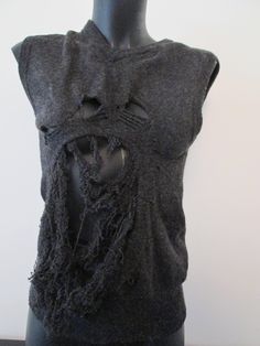 This unique piece of clothes is a second hand vest sweater that has been 'de-knitted' at some parts and re-knitted differently by hand, in a 'grungy-destroyed' way, using ancient artisanal techniques of repairment. It is size 36 FR and also convenient for a 34 FR and a 38 FR. It is pure lambswool, mottled dark grey color. Grunge Knit Crew Neck Sweater, Knitted Crew Neck Winter Vest, Winter Knitted Crew Neck Vest, Winter Crew Neck Knitted Vest, Winter Crew Neck Knit Sweater Vest, Knitted Crew Neck Vest For Fall, Fall Knitted Crew Neck Vest, Fall Crew Neck Knitted Vest, Fitted Grunge Vest For Fall