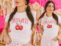 "Looking for a sorority tee that's on trend? 🫶🏻 This Cherry Bomb Baby Tee is the answer! Whether you're giving this tee as a gift or treating yourself with something new, you'll be obsessed with this trendy sorority crop top! 🌊 YOU'LL LOVE THIS STYLE 🌊 Looking for a sorority basic that's on trend? The white baby tee is the perfect choice! Made with super soft and breathable fabric, this crop top features thicker seams on the collar and sleeves for a more quality feel. The true-to-size form-fitting design is perfect for showing off your figure. But if you prefer a looser look, don't hesitate to size up.  🌊 YOU'LL LOVE THIS DESIGN 🌊 Its the cherry on top! This bright cherry design is perfect for a fun and trendy tee. Featuring a bright pair of cherries and your sorority name arched abo School Spirit T-shirt For Game Day In Spring, Preppy Graphic Print Crew Neck Top, Preppy Crew Neck Top With Graphic Print, Pink Sorority T-shirt For Summer, Sorority Cotton T-shirt For Spring, Sorority Style Cotton T-shirt For Spring, Pink Sorority T-shirt With Crew Neck, Spring Sorority Cotton T-shirt, Sorority Crew Neck T-shirt