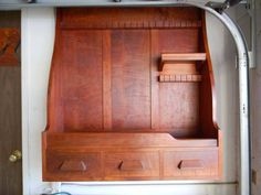 a wooden shelf with drawers on top of it