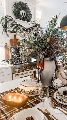 a dining room table is set with dishes and place settings