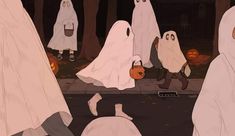 there are many people dressed up as ghostes walking down the street with pumpkins