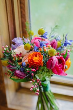 a bouquet of flowers sitting on top of a window sill