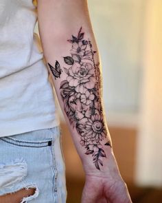 a woman with a flower tattoo on her arm