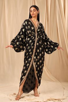 Editor's Note Unlock Your Glamour Quotient With This Black Crepe Kaftan. While Its V-neckline, Elasticated Balloon Sleeves, Cinched Waist And Front Slit Opening Gives Your Figure The Added Oomph, It Also Has A Beautiful Coco Foil Print Along With Embellished Borders. This Kaftan Comes With A Slip. Fabric: Crepe Color: Black Fit: Semi Fit Care: Strictly Dry Clean Only For Digitally Printed Garments & Non-petroleum Dry Clean For Hand-printed Garments. Disclaimer: The Actual Print-placement Of The Caribbean Fashion, Kaftan For Women, Black Kaftan, Short Kaftan, Long Kaftan, Draped Skirt, Lakme Fashion Week, Floral Print Shorts, Pant Set