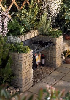 an outdoor kitchen made out of bricks and plants