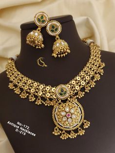 Description :- Indian Choker Necklace and Earrings Set, High Gold Choker Set For Women Wedding Gift Gift yourself a royal look with this perfectly crafted kundan necklace set from Manalisstudio. Crafted with high quality kundan stones and pearls, it is impressive in design. The green enamel artwork adds perfect texture to the design. Perfect for weddings and festivities, this antique necklace set should be put on with your favorite sari or lehenga. 100% Satisfaction. Long Lasting Plating, High-Q Vintage Jewelry For Weddings And Festivals, Heavy Round Bridal Necklace For Anniversary, Vintage Chandbali Necklaces For Wedding, Vintage Jewelry Sets For Wedding And Festivals, Vintage Jewelry Sets For Weddings And Festivals, Vintage Bridal Necklace For Wedding, Vintage Gold Kundan Necklace For Wedding, Vintage Kundan Necklace For Wedding And Festive Occasions, Vintage Meenakari Necklaces For Wedding