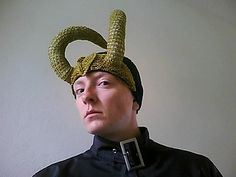 a man wearing a weird hat with horns on his head