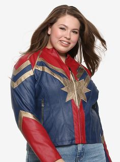 a woman in a captain america costume posing for the camera with her hair blowing in the wind