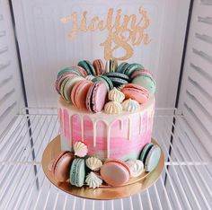 a birthday cake decorated with macaroons and icing