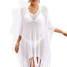 The Anna-Kaci Women's Mesh Knit Cover-Up with Tassel Hem and V-Neck Design is a stylish and versatile piece perfect for beach or poolside lounging. Crafted from lightweight, breathable mesh knit fabric, this cover-up features a flattering V-neck design that adds a touch of elegance. The tassel hem detail enhances its bohemian charm, creating a playful and chic look. Ideal for layering over swimsuits, this cover-up offers just the right amount of coverage while keeping you cool and comfortable. W Casual V-neck Cover-up With Tassels, Summer V-neck Top With Tassels, Summer V-neck Tops With Tassels, Spring Knit V-neck Cover-up, Casual V-neck Top With Fringe, Casual V-neck Tassel Cover-up, Knit V-neck Beach Cover-up, Summer V-neck Top With Fringe, Bohemian Knit V-neck Cover-up