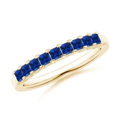 a yellow gold ring with blue sapphire stones