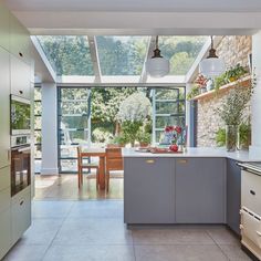 a kitchen with an oven, sink and table in the center is seen from outside