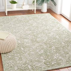 a large rug in the middle of a room with potted plants on the floor