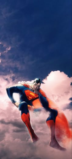 a man flying through the air while wearing a superman costume