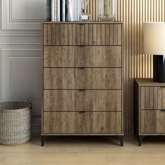 a wooden dresser sitting next to a lamp on top of a table