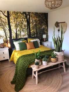 a bedroom decorated in green and yellow with potted plants on the side table next to the bed