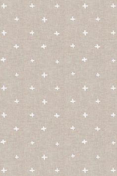 a beige background with small white crosses on the top and bottom of it, as well as some smaller dots