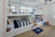 a bedroom with two bunk beds and white walls