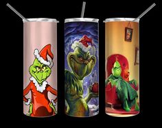 three different colored tumblers with the same character on them, one in santa's hat