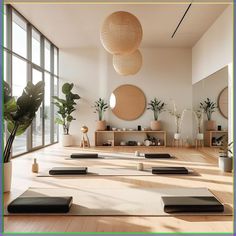 a room with yoga mats, potted plants and round mirrors