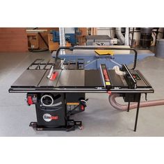 a table sawing machine sitting on top of a floor