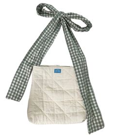 a green and white checkered bag with a bow on the top, tied to it