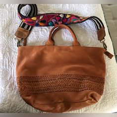 Beautiful Boho Vibe Genuine Leather Handbag In Saddle Brown. Handbag Made In India. Included Is A Brand New Embroidered Bag Strap Made In Guatemala. Bag Was Only Used Once. Not My Daughters Style. Originally Paid Well Over $200 For Both In May. Selling For Only $75. Embroidered Leather Shopping Bag, Casual Brown Embroidered Bag, Embroidered Brown Hobo Shoulder Bag, Embroidered Brown Hobo Tote Bag, Brown Embroidered Hobo Shoulder Bag, Embroidered Brown Tote Hobo Bag, Embroidered Brown Hobo Bag, Embroidered Leather Satchel Bag, Embroidered Leather Travel Bags