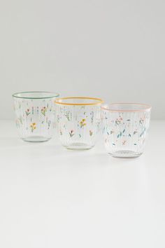 three glass bowls with floral designs on them