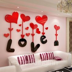 the living room is decorated with red hearts and love letters on the wall above the couch