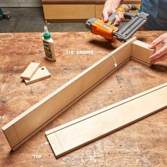 a person using a planer to make a piece of wood that is being worked on