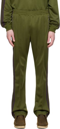 Polyester interlock jersey track pants. · Concealed drawstring at elasticized waistband · Three-pocket styling · Logo graphic embroidered at front · Pinched seam at legs · Striped knit trim at outseams Supplier color: Olive Mens Khakis, Sports Logo, Striped Knit, Logo Graphic, Track Pants, Apparel Accessories, Active Wear, Track, Trim